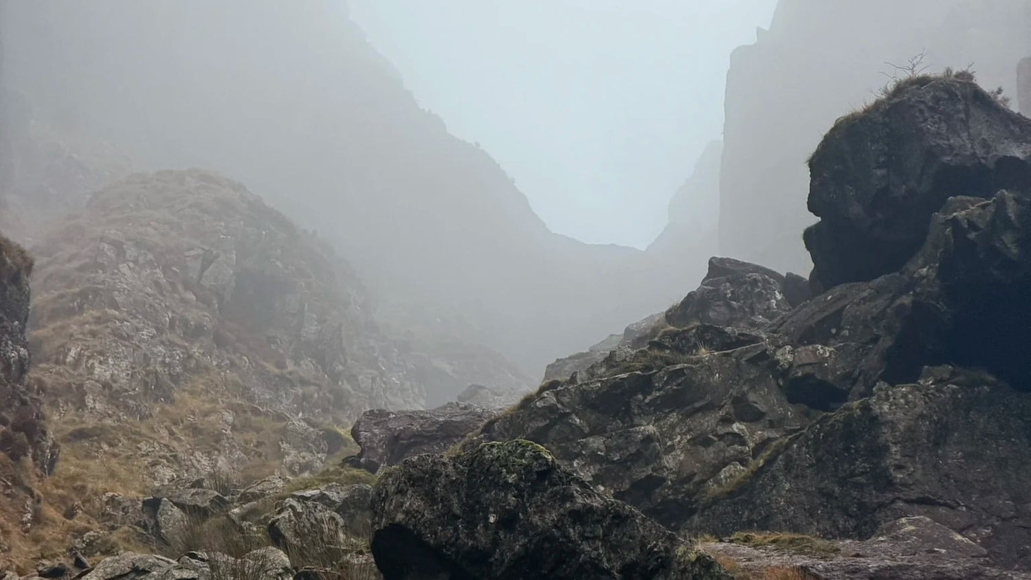 Rugged mountain landscape with rocks and fog
