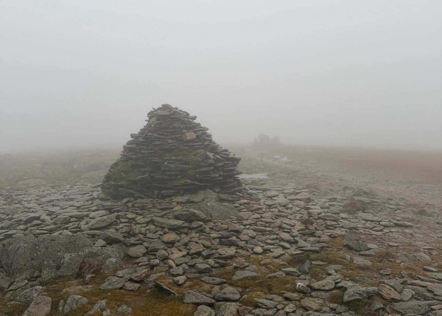 Stone cairn on a misty landscape